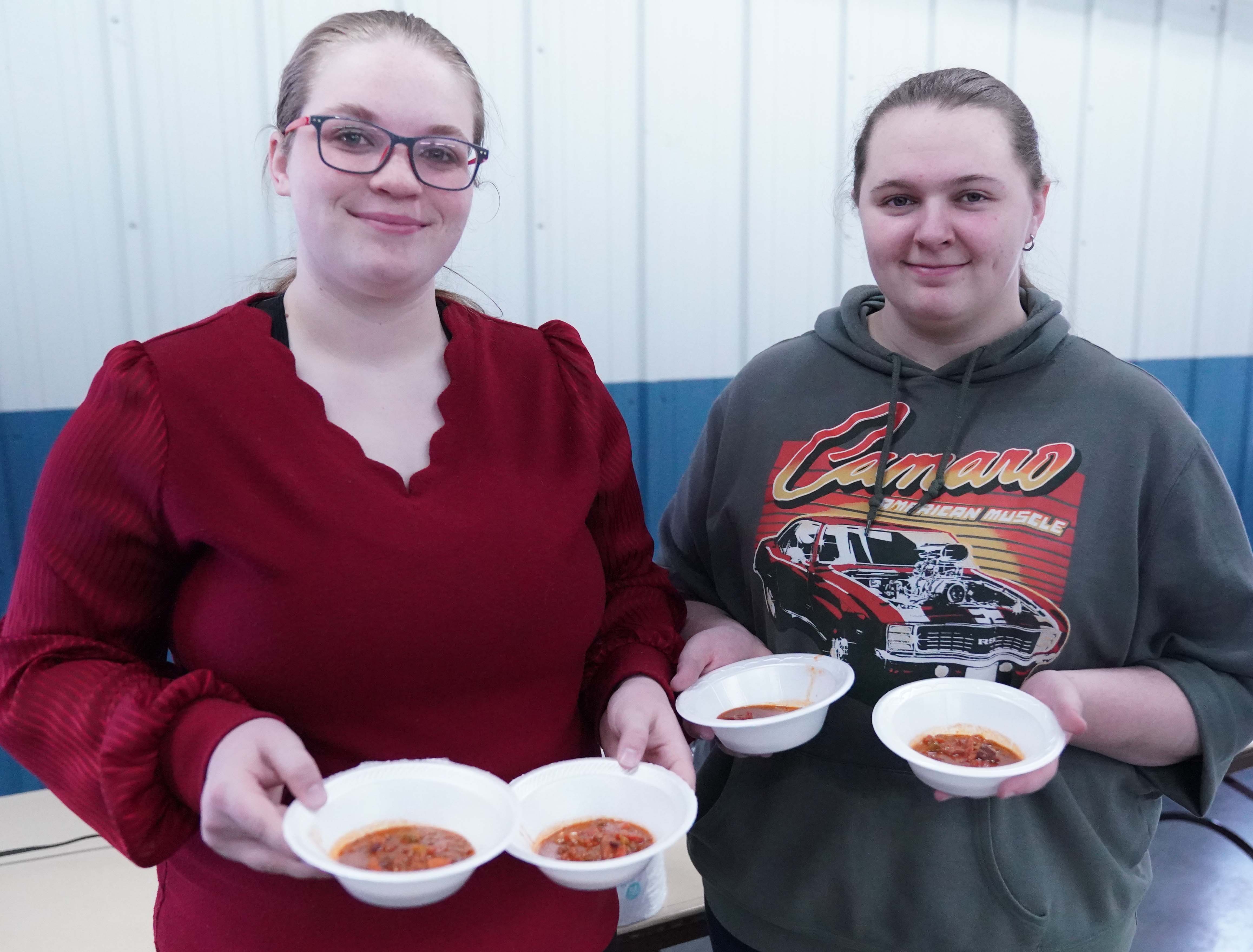 McCook Community College music students Paige Bopp (left) and Izabella Schmidt helped serve up bowls of chili at the 22nd Annual Dick Driml Chili Cook-Off.