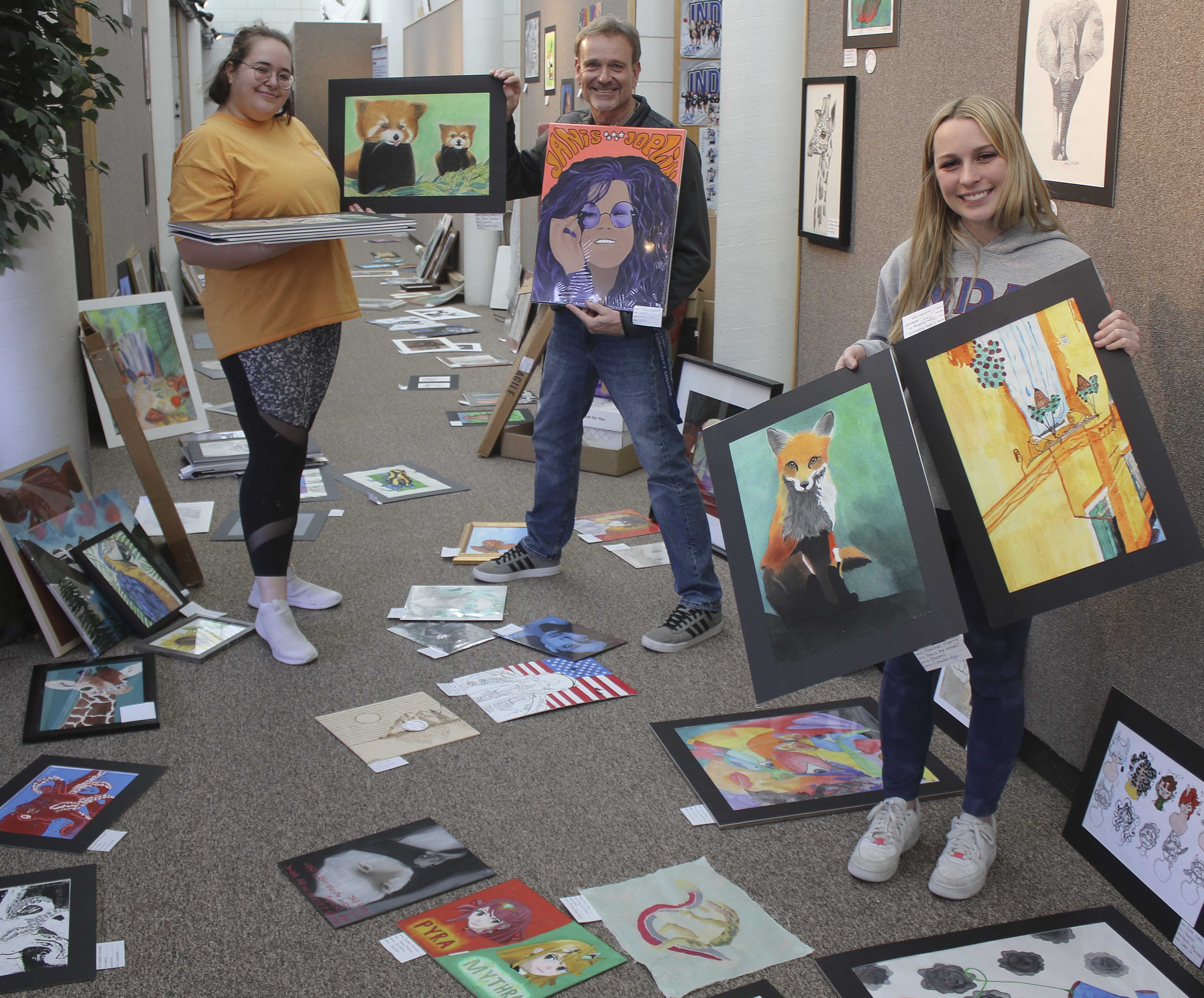 MCC Art Department members sort and hang the 2022 MCC Paint-In Show