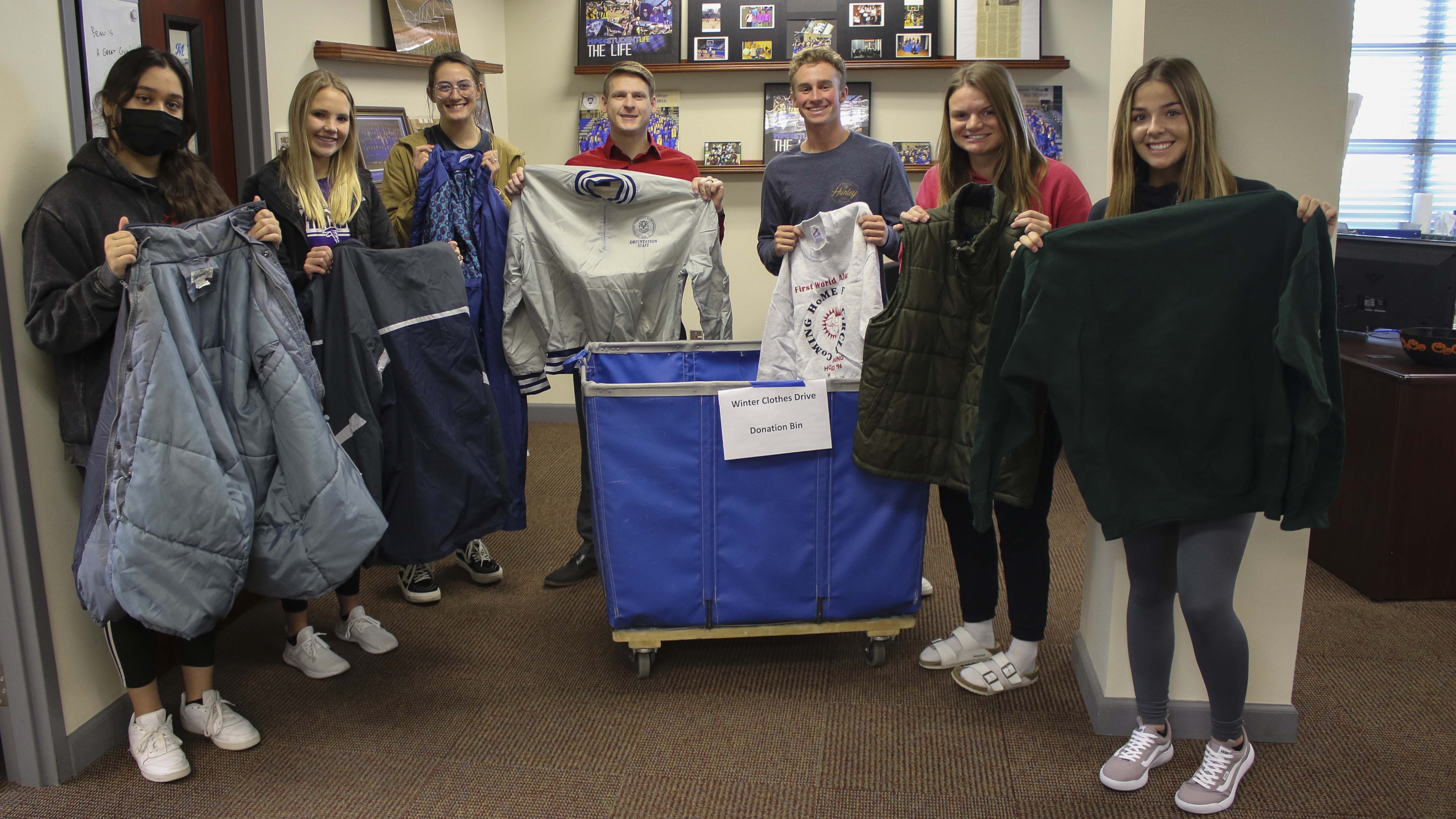 MCC Student Senate members gather around the coat bin.