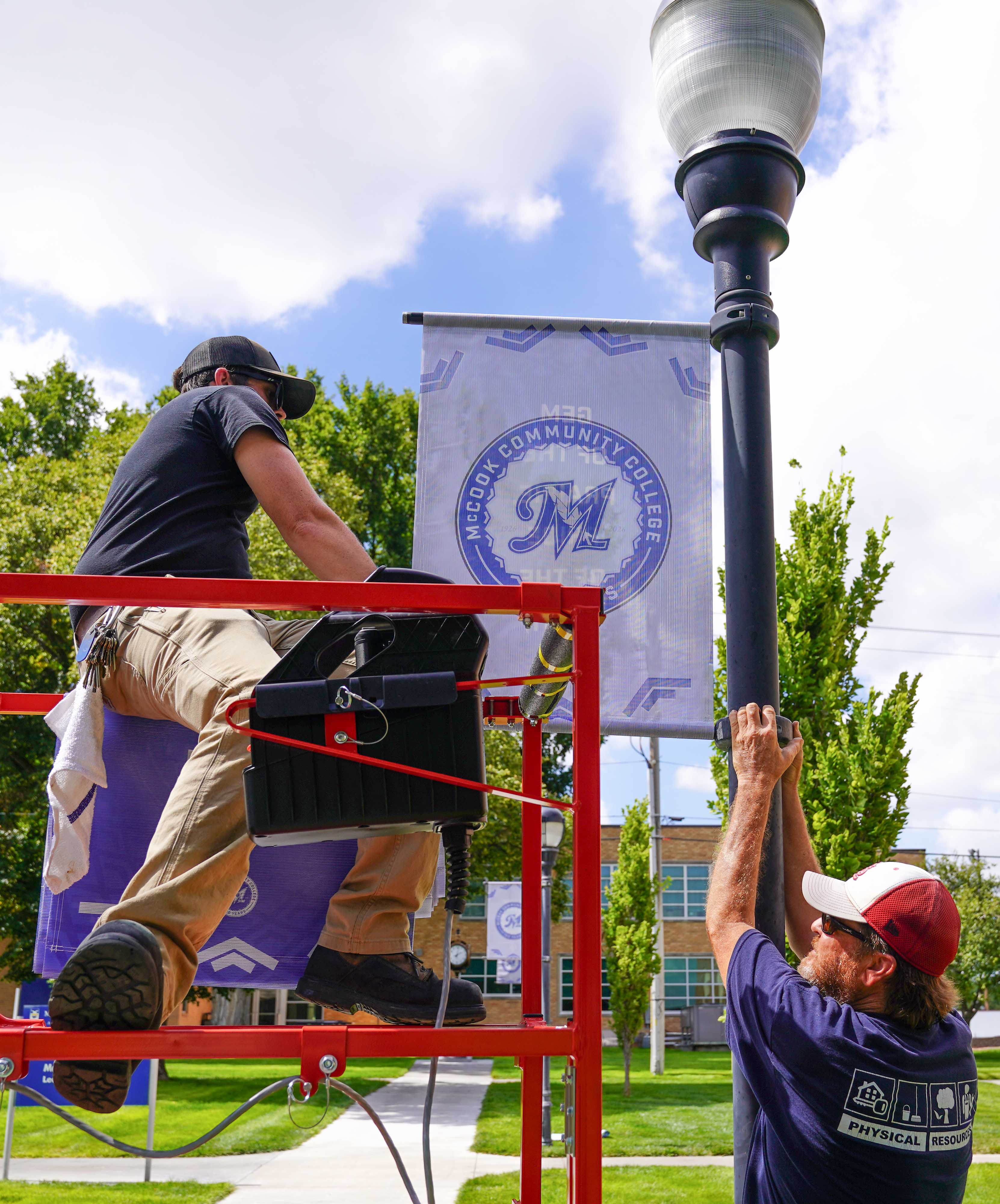 MCC staff install banners for 100th year celebration
